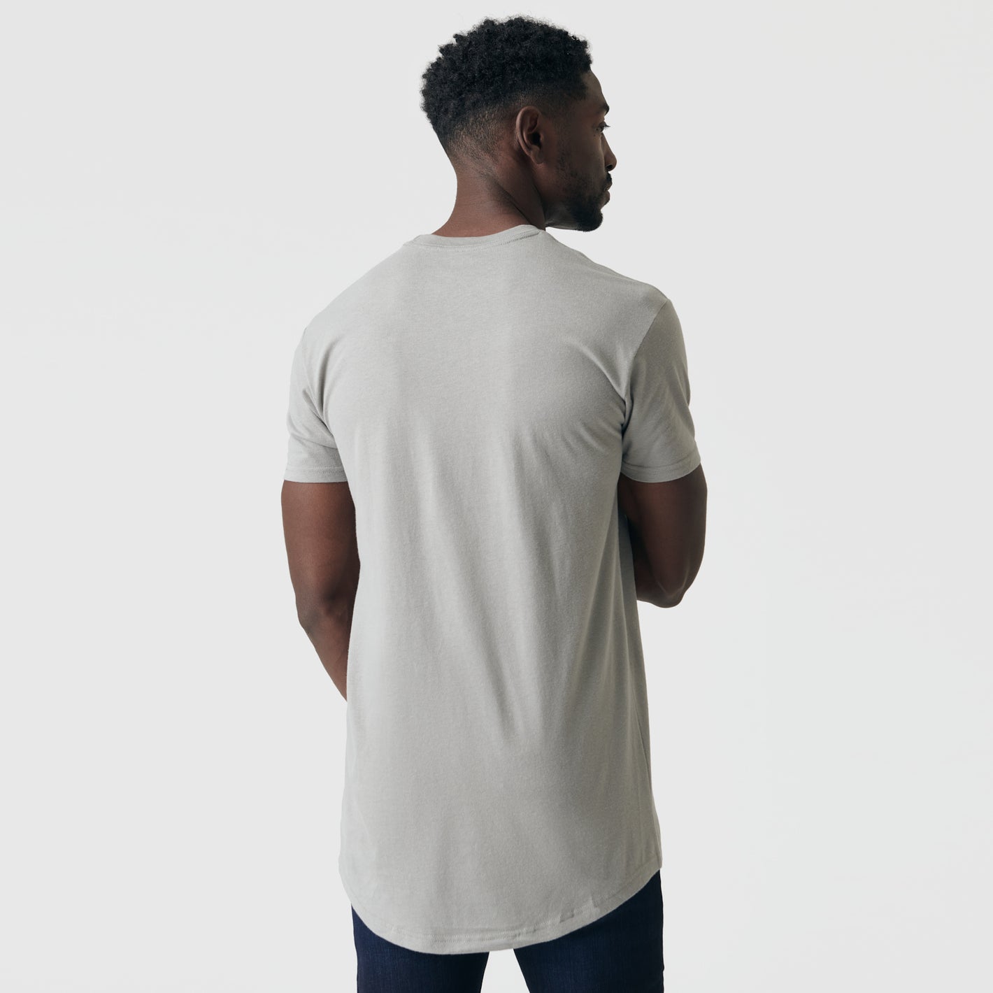 Man wearing Iron Gray Tall Round Hem Crew Neck T-Shirt, back view.
