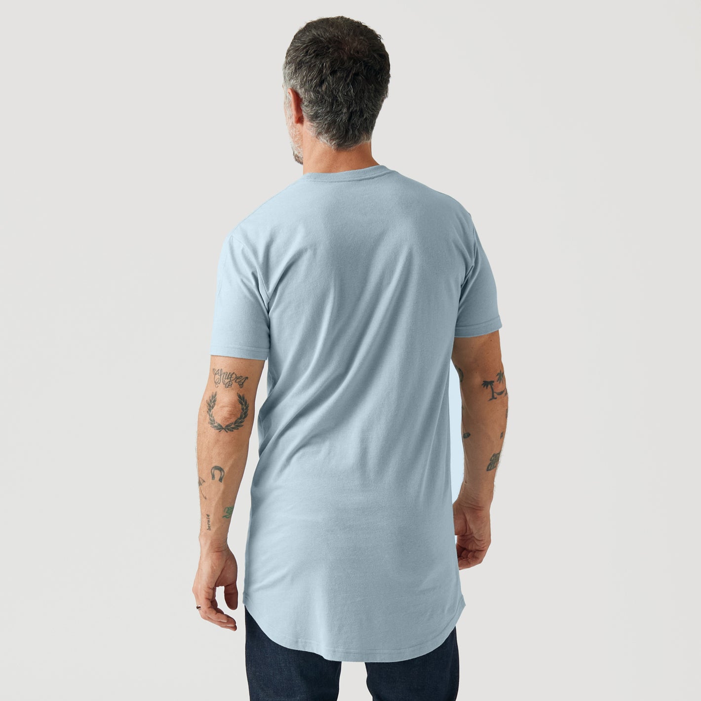 Man in Pale Blue Tall Round Hem Crew Neck T-Shirt.