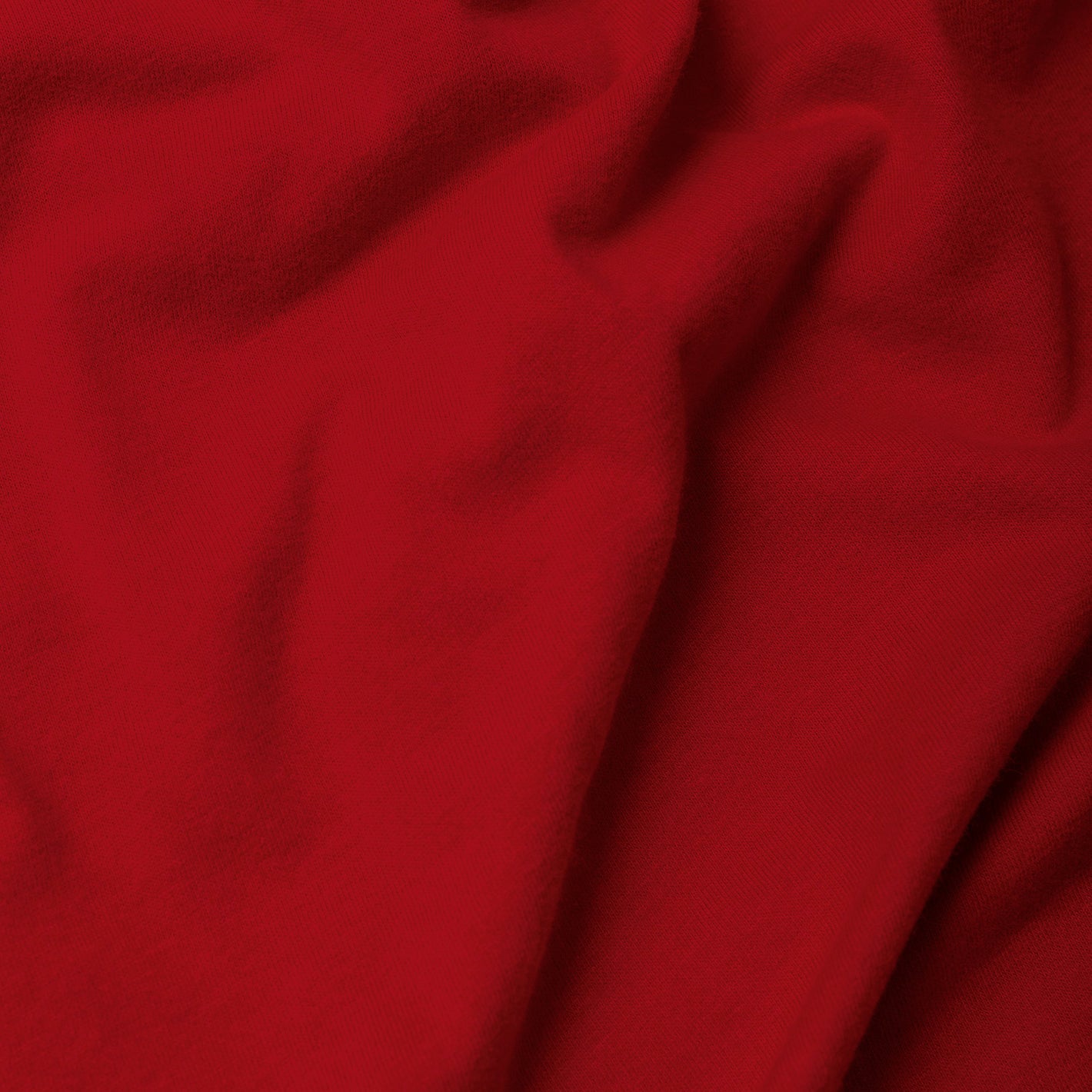 Red Long Sleeve Crew Neck Tee with soft fabric texture and subtle wrinkles.