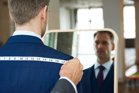 Man getting measured for a custom fitted shirt