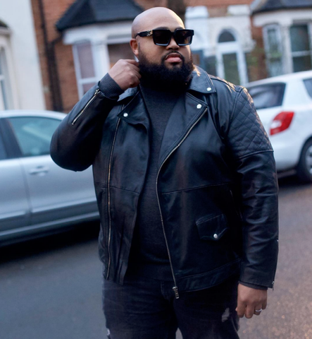 bearded man in leather jacket wearing sunglasses