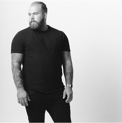 Black and white photo of bearded man wearing a True Classic Black crew neck T-shirt