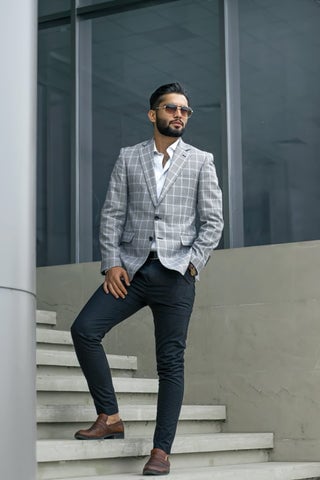 Man wearing jeans with button up shirt and blazer 